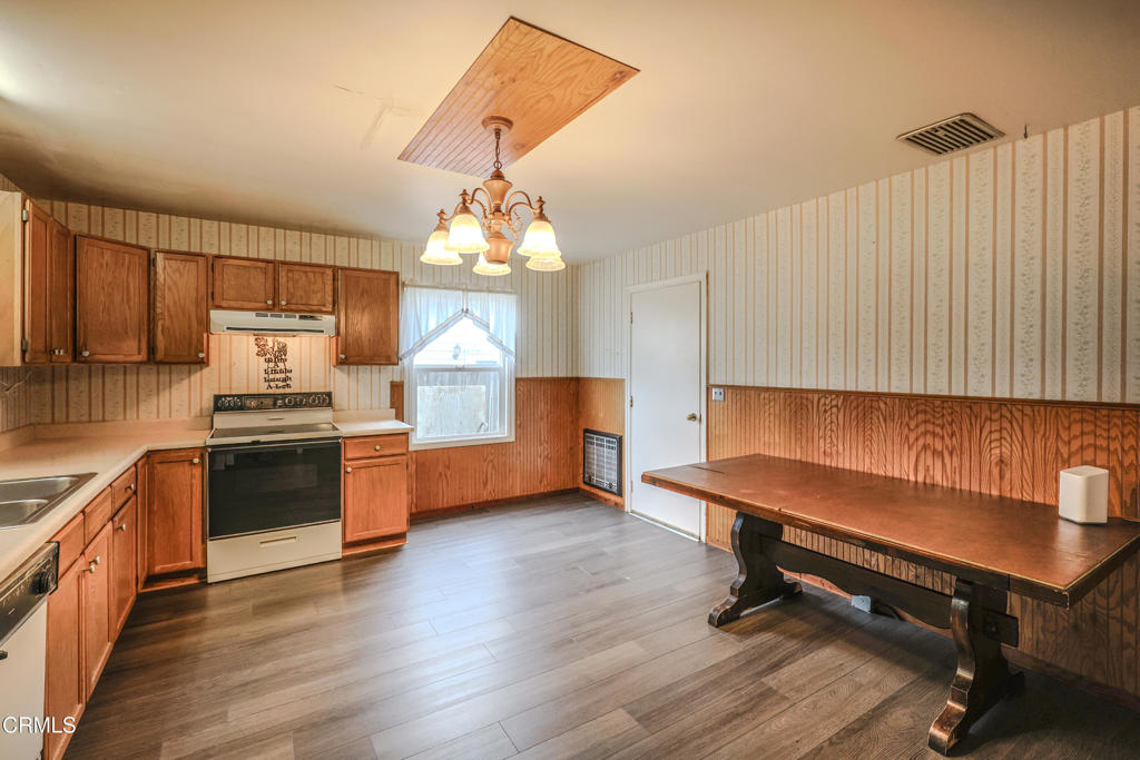 826 Cedar Street Fort Bragg, CA 95437 - Photo 10 of 42 a kitchen with a sink dishwasher a stove and a microwave oven with wooden floor