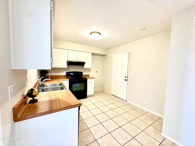 a kitchen with stainless steel appliances granite countertop a sink and a stove