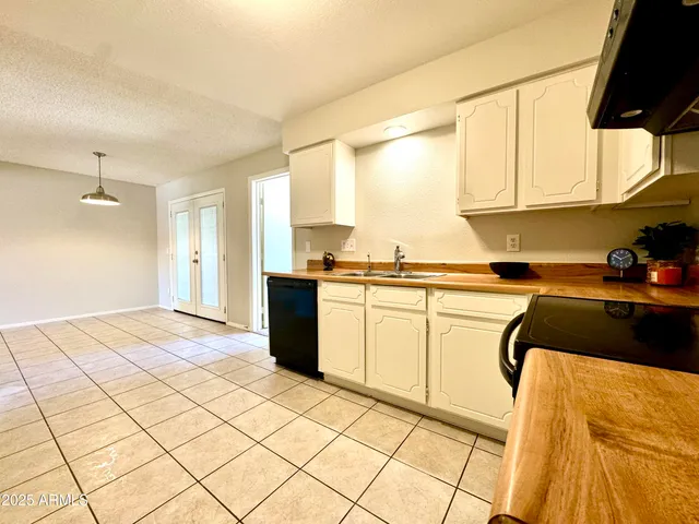 an empty room with windows and cabinet