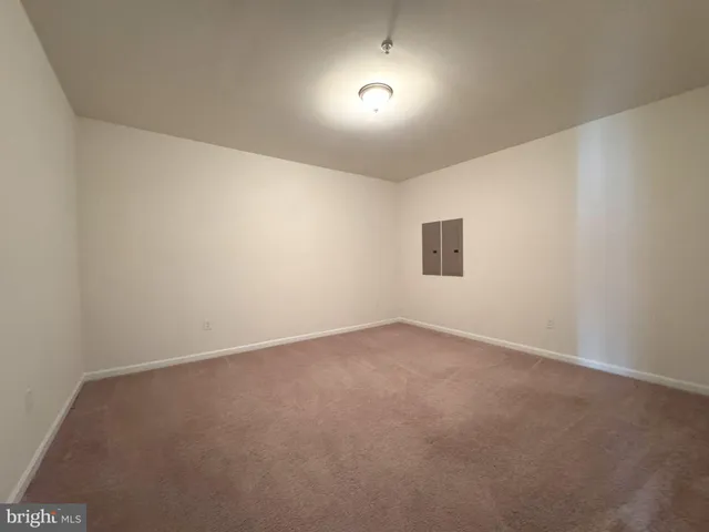 a view of an empty room and a window