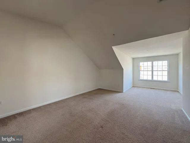 a bathroom with a tub a sink and a mirror