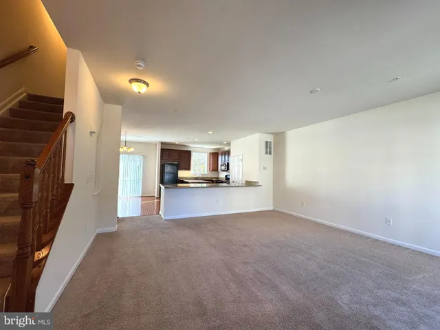 a view of a kitchen with a sink and a refrigerator
