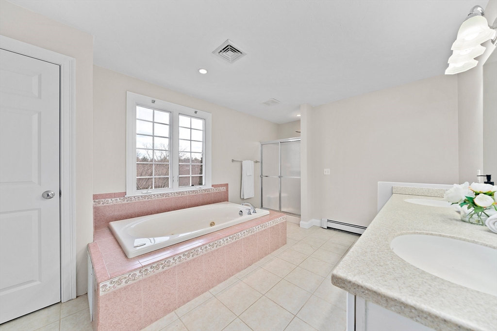 34 Forest Street Hanover, MA 02339 - Photo 25 of 42 a spacious bathroom with a tub sink and mirror