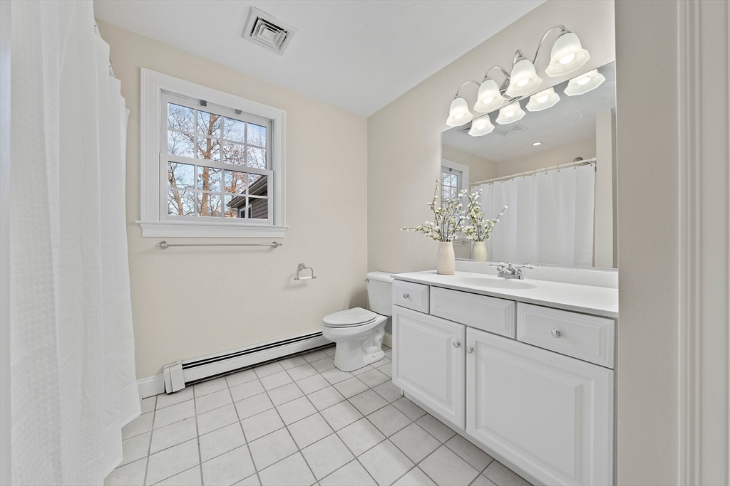 34 Forest Street Hanover, MA 02339 - Photo 28 of 42 a spacious bathroom with a toilet sink and mirror