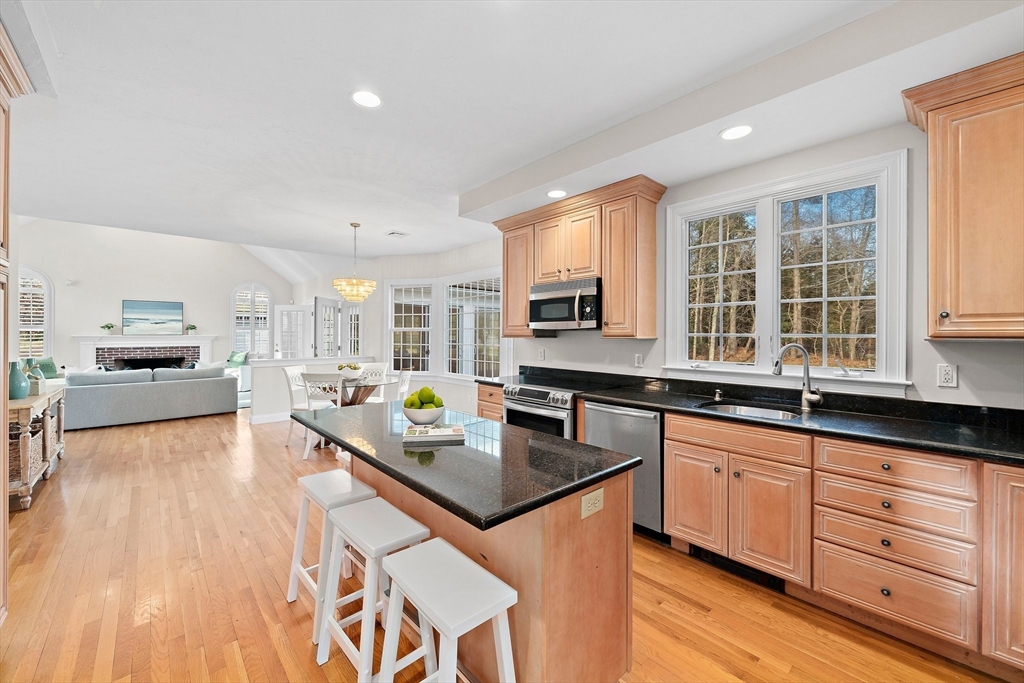 34 Forest Street Hanover, MA 02339 - Photo 3 of 42 a large kitchen with kitchen island a large counter top space a sink stainless steel appliances and cabinets