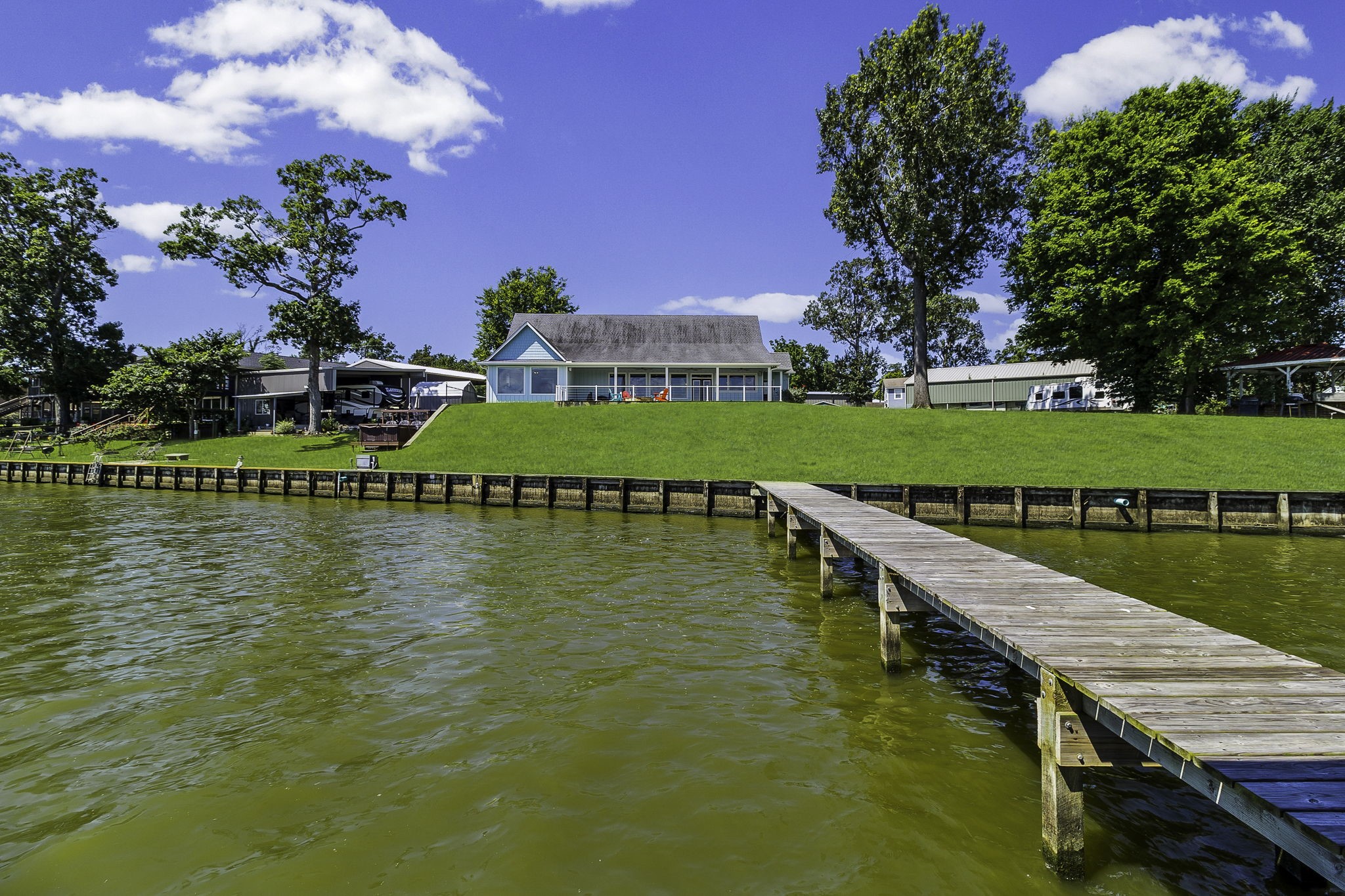 151 Key Largo Loop Point Blank, TX 77364 - Photo 37 of 49 Enjoy the shoreline, a gently sloping lawn to the water, and a private pier extending into the lake for easy access to boating, fishing and waterfront recreation.