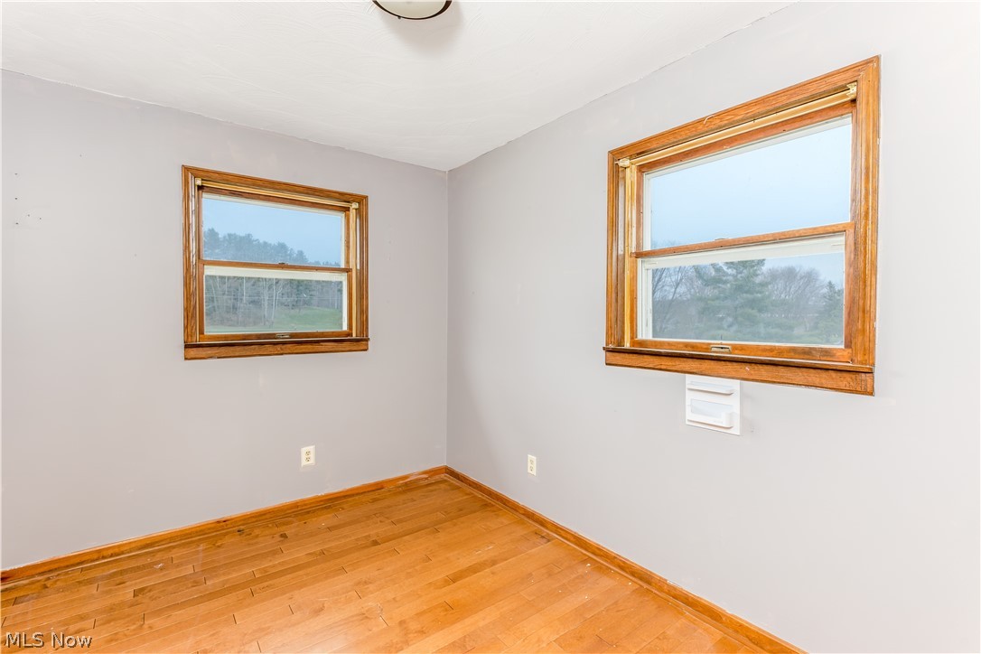 8750 Whitaker Road Cambridge, OH 43725 - Photo 17 of 29 Unfurnished room with light hardwood / wood-style flooring