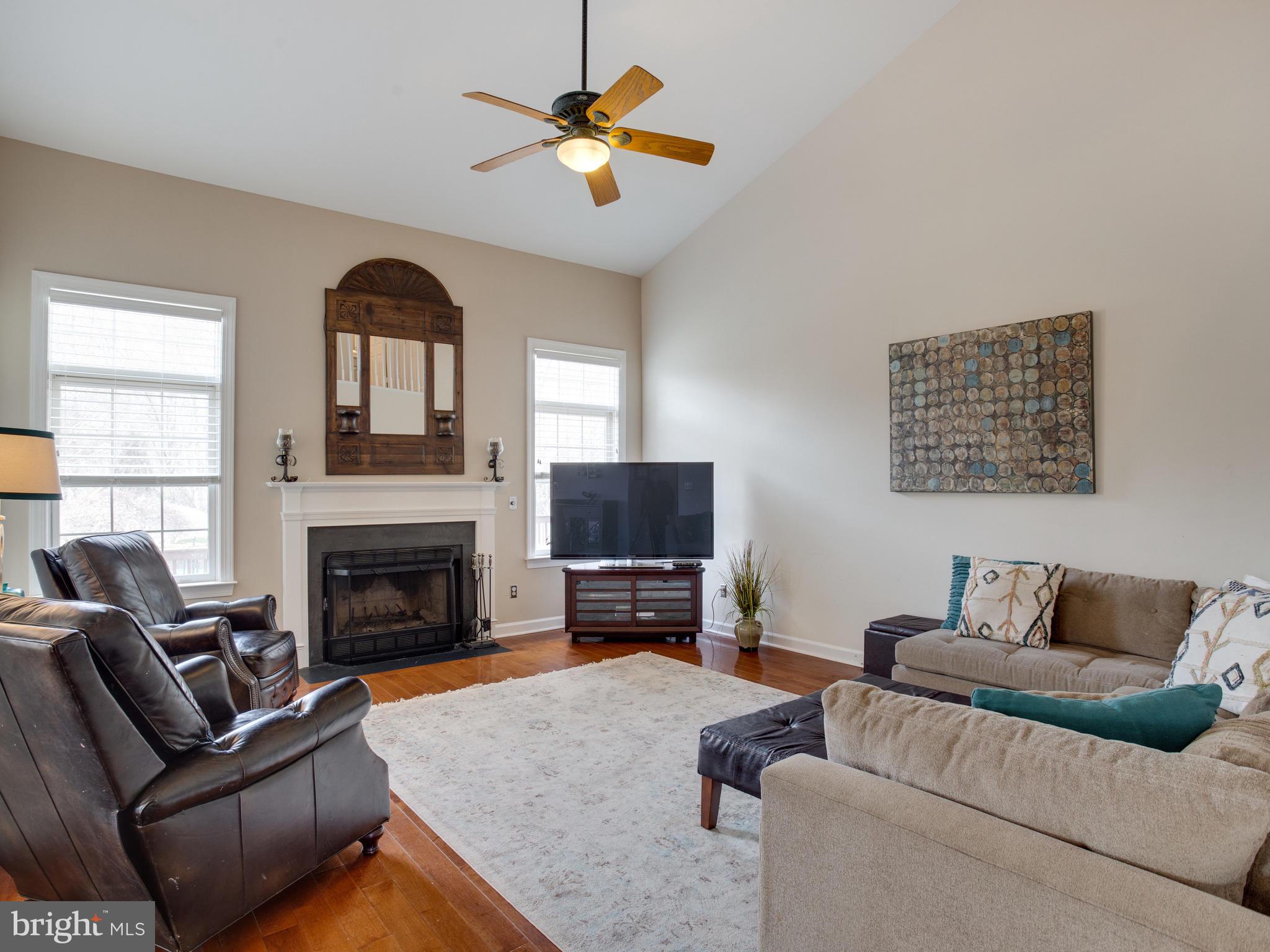 3235 Breckenridge Way Riva, MD 21140 - Photo 19 of 63 a living room with furniture flat screen tv and a fireplace