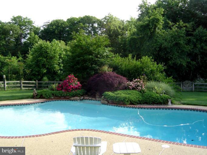 3235 Breckenridge Way Riva, MD 21140 - Photo 62 of 63 a view of a swimming pool with a garden
