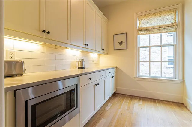a kitchen with wooden cabinets and a stove top oven