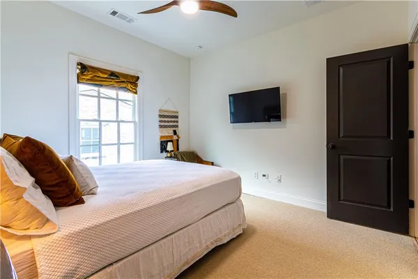a bedroom with a bed and a flat screen tv