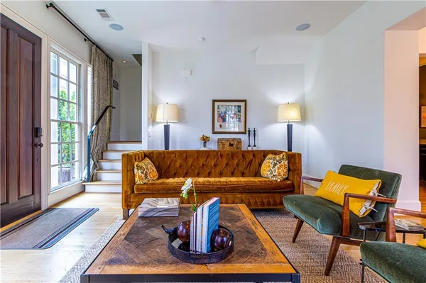 a living room with furniture and a lamp