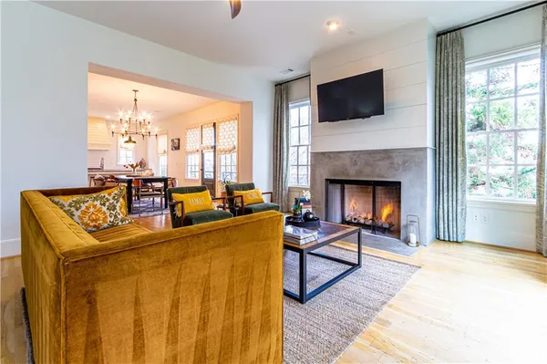 a living room with furniture a flat screen tv and a fireplace