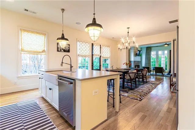 a kitchen with sink stove and view living room