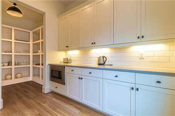 a kitchen with granite countertop white cabinets and stainless steel appliances