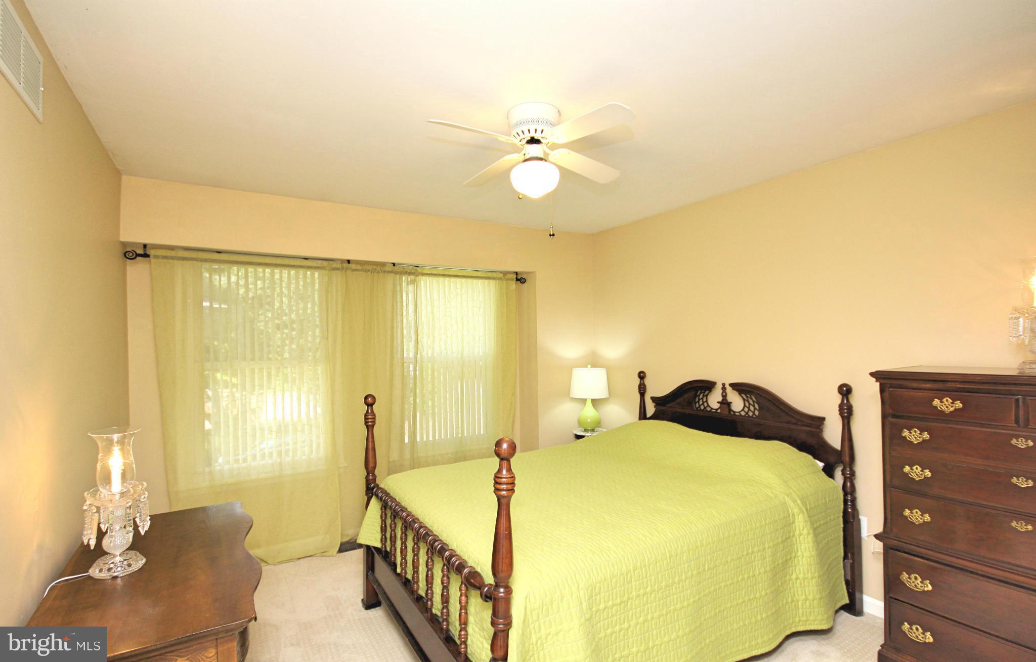 7707 Mahogany Road Severn, MD 21144 - Photo 16 of 30 a bedroom with a bed and wooden floor