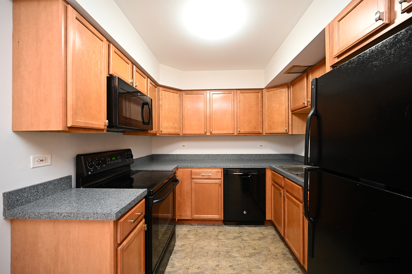 2230 South Goebbert Road, Unit 339 Arlington Heights, IL 60005 - Photo 12 of 38 a kitchen with stainless steel appliances granite countertop a stove a sink and a microwave