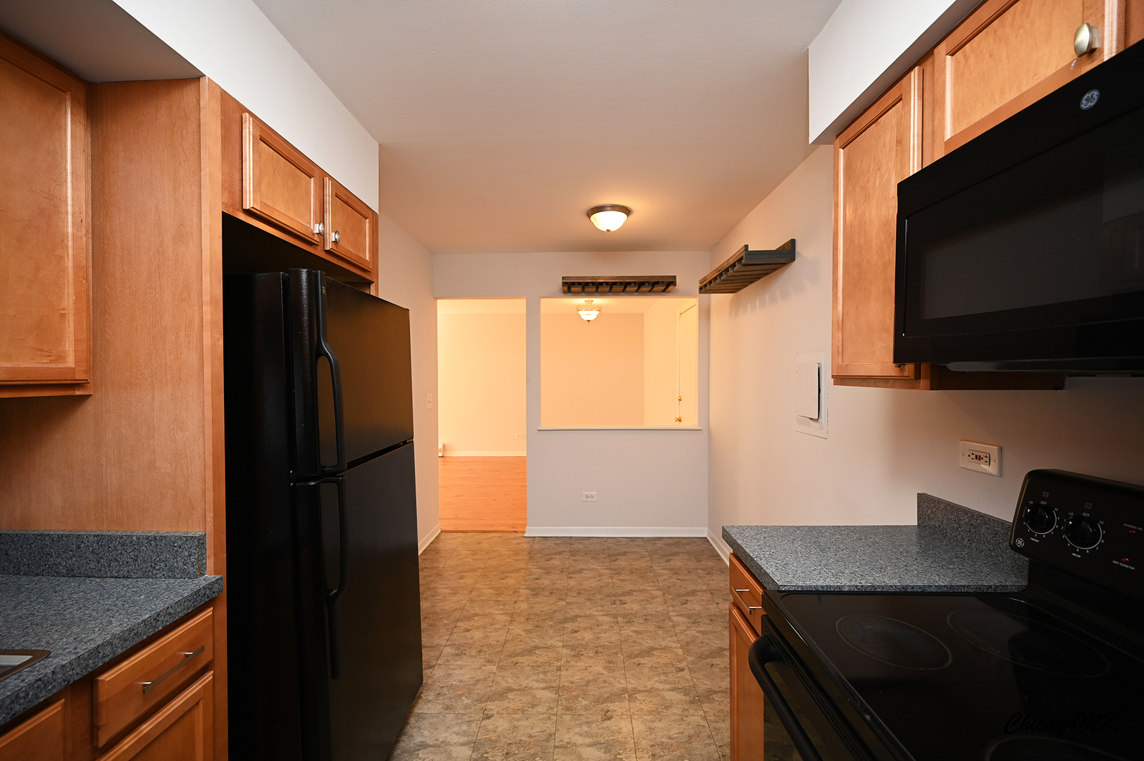 2230 South Goebbert Road, Unit 339 Arlington Heights, IL 60005 - Photo 17 of 38 a kitchen with a refrigerator stove and microwave