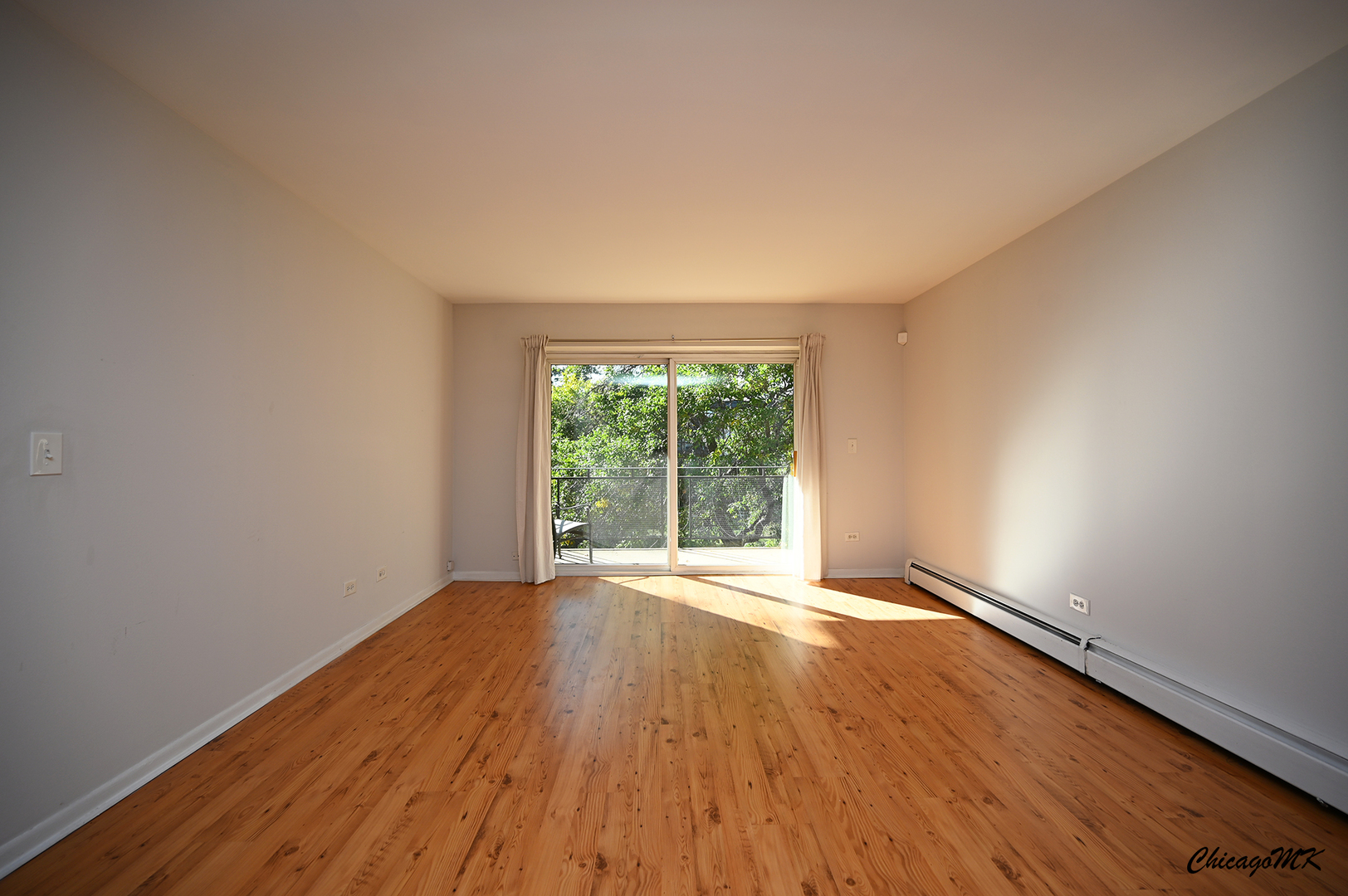 2230 South Goebbert Road, Unit 339 Arlington Heights, IL 60005 - Photo 3 of 38 a view of an empty room with wooden floor and a window