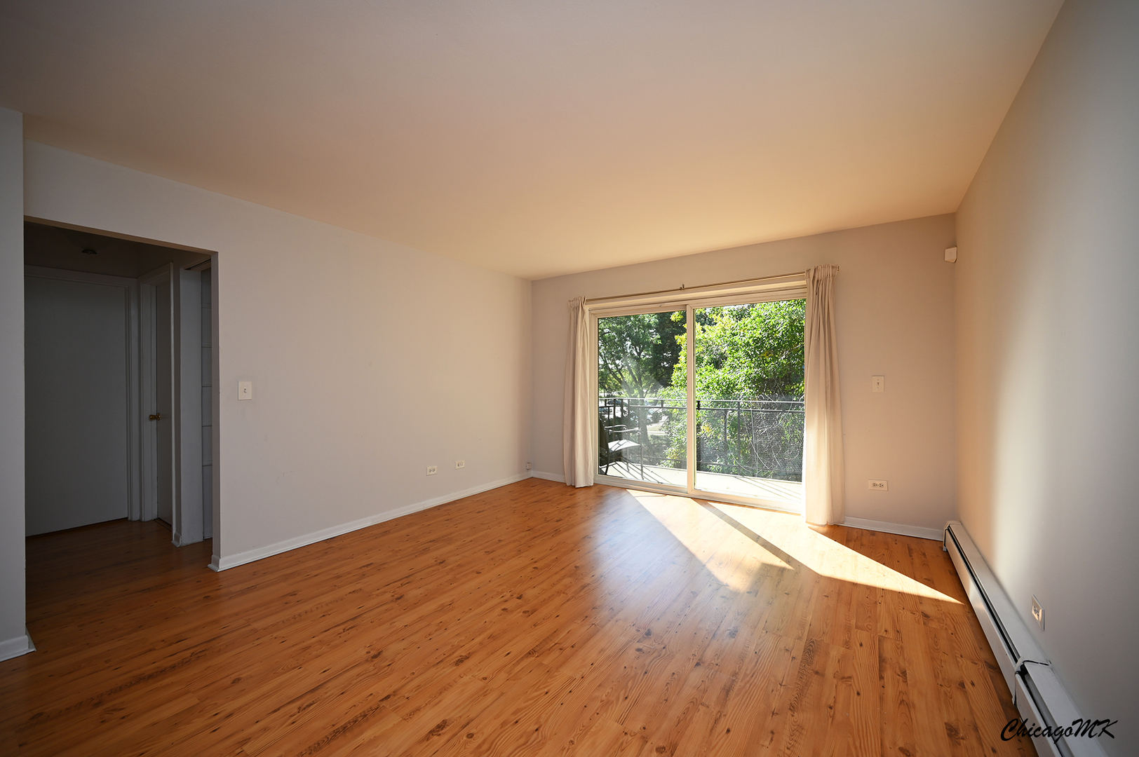 2230 South Goebbert Road, Unit 339 Arlington Heights, IL 60005 - Photo 4 of 38 a view of an empty room with wooden floor and a window
