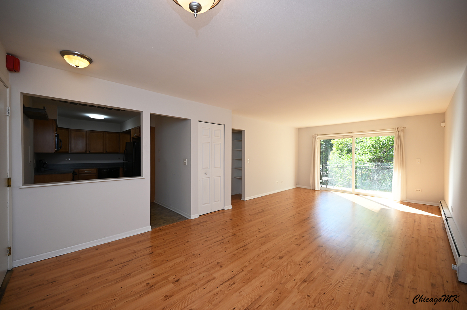 2230 South Goebbert Road, Unit 339 Arlington Heights, IL 60005 - Photo 7 of 38 a view of an empty room with wooden floor and a window