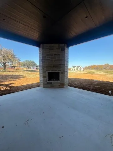 a view of kitchen with refrigerator and window