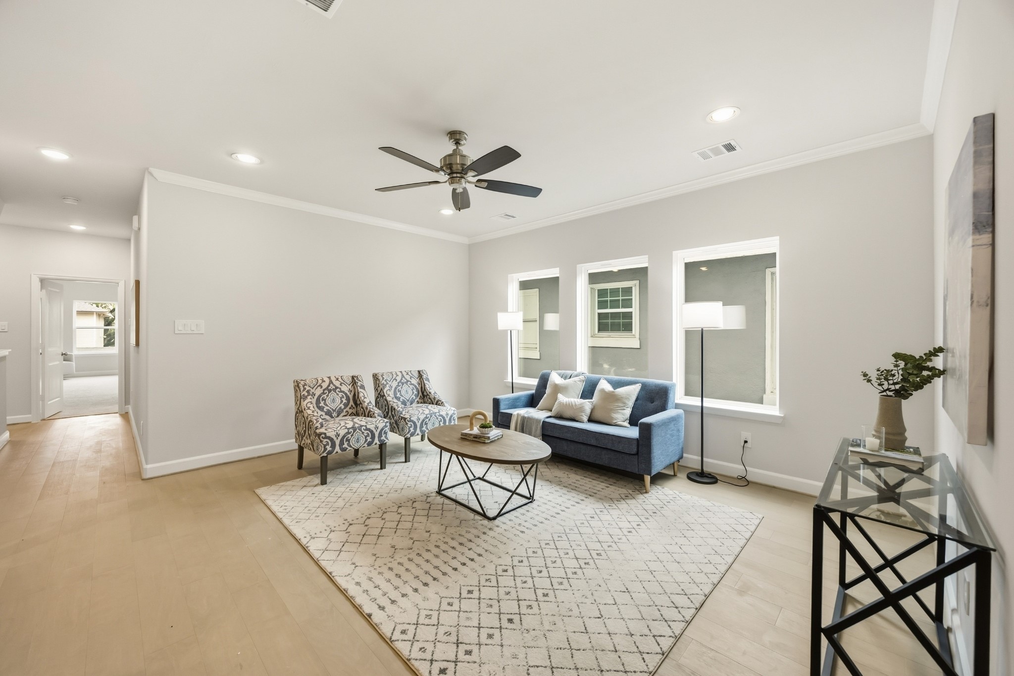 4317 Roseland Street, Unit B Houston, TX 77006 - Photo 14 of 29 The second-story game room, a realm of leisure nestled between the serenity of the primary suite and the charm of a secondary bedroom, brightened by an expansive wall of windows.