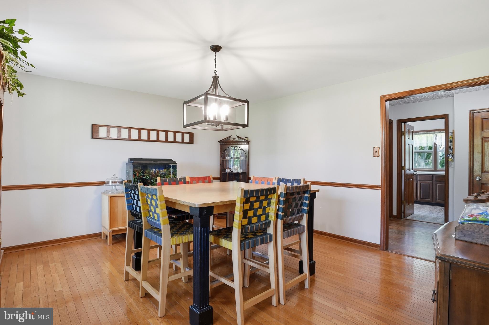 6118 Fishers Station Road Lothian, MD 20711 - Photo 15 of 62 a view of a dining room with furniture wooden floor and chandelier