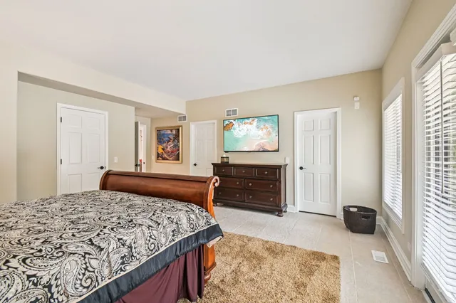 an aerial view of a house with a yard and large trees