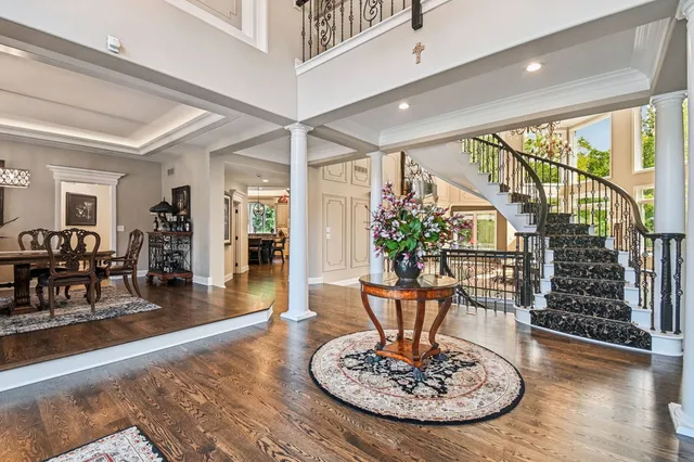 a living room with furniture large window and dining table