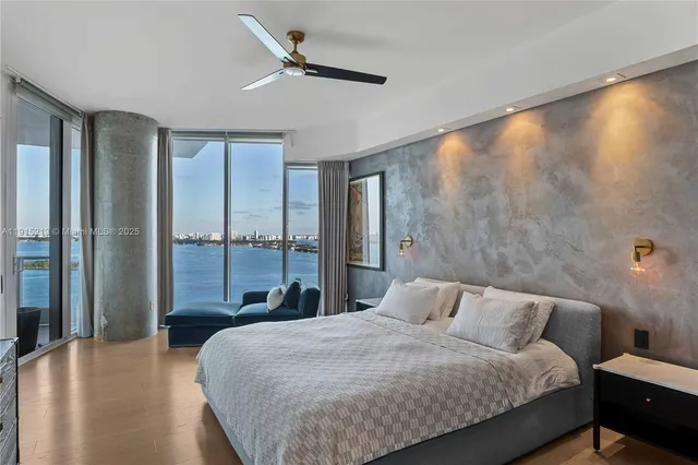 a bedroom with a large bed and a large window