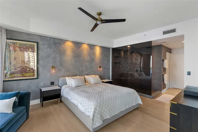 a bedroom with a bed and a chandelier