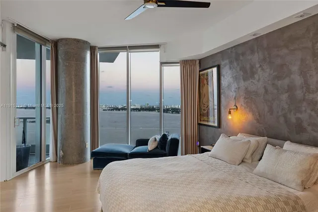 a bedroom with a large bed and a chandelier