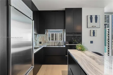 a kitchen with a sink and refrigerator
