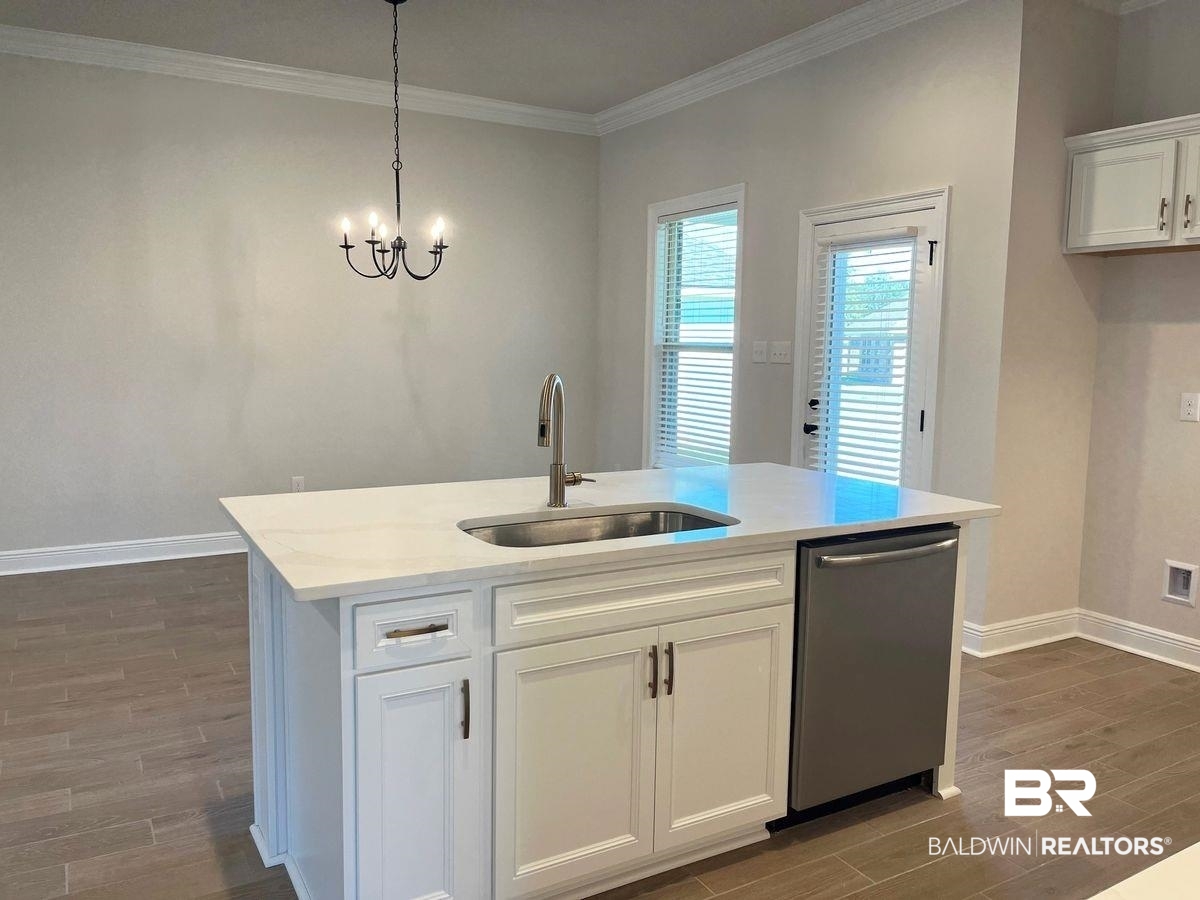 1733 Breckinridge Place Foley, AL 36535 - Photo 5 of 18 Kitchen with dark wood-type flooring, white cabinets, dishwasher, a center island with sink, and sink