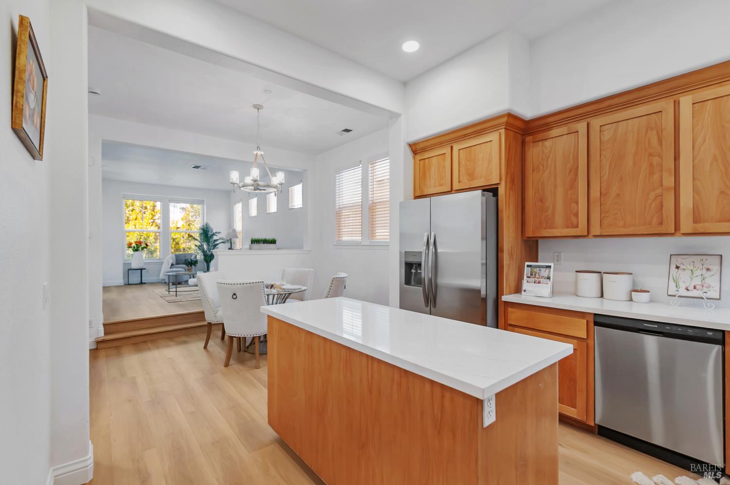 4242 Streamside Drive Santa Rosa, CA 95409 - Photo 12 of 29 a kitchen with stainless steel appliances a sink a stove a refrigerator cabinets and living room view