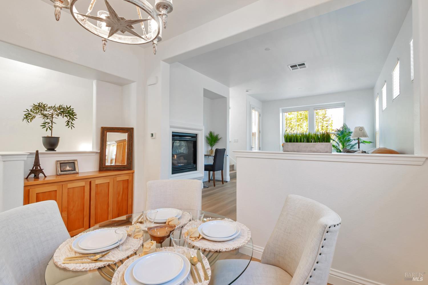 4242 Streamside Drive Santa Rosa, CA 95409 - Photo 15 of 29 a dining room with furniture a large window and wooden floor