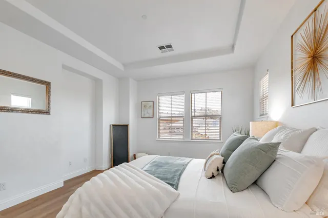 a bedroom with a bed and a large window