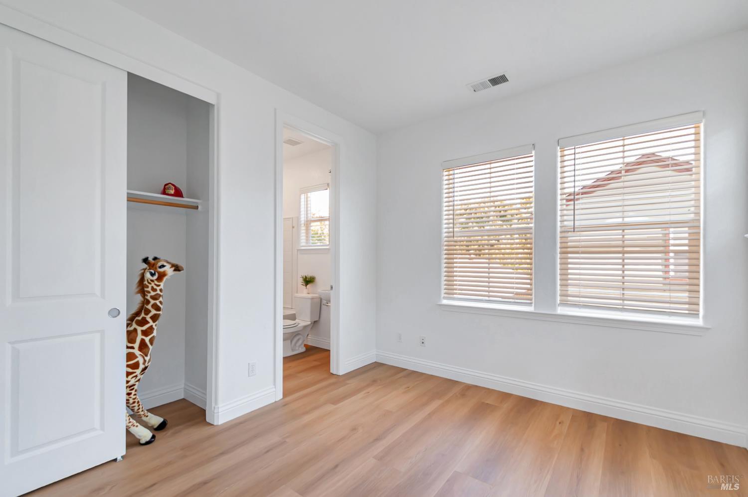 4242 Streamside Drive Santa Rosa, CA 95409 - Photo 22 of 29 a view of an empty room with wooden floor and a window