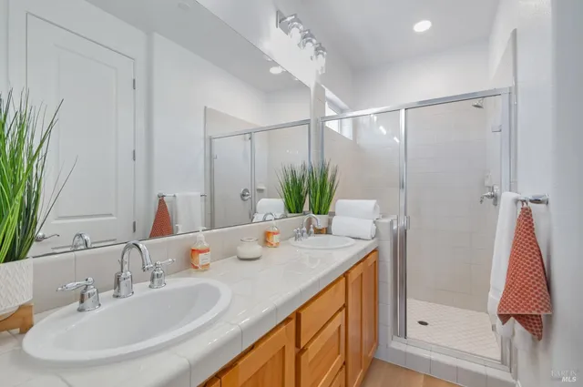 a bathroom with a double vanity sink and a mirror
