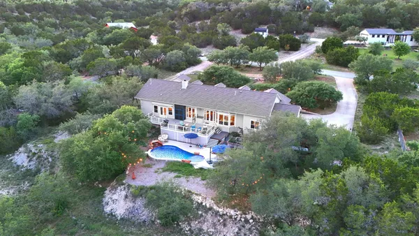 an aerial view of a house with yard swimming pool and outdoor seating