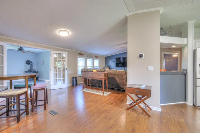 a living room with furniture window and wooden floor