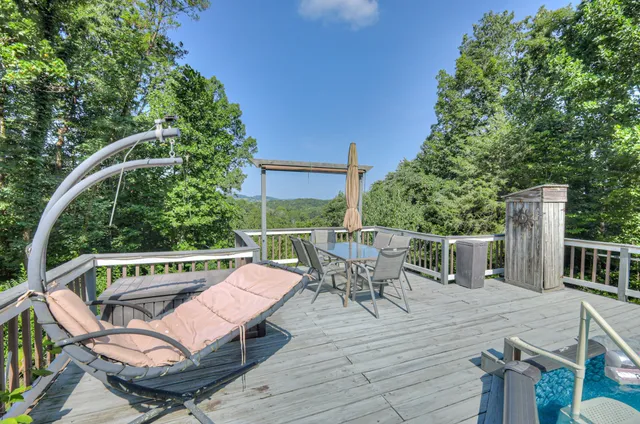 a view of a chairs and table on the wooden deck