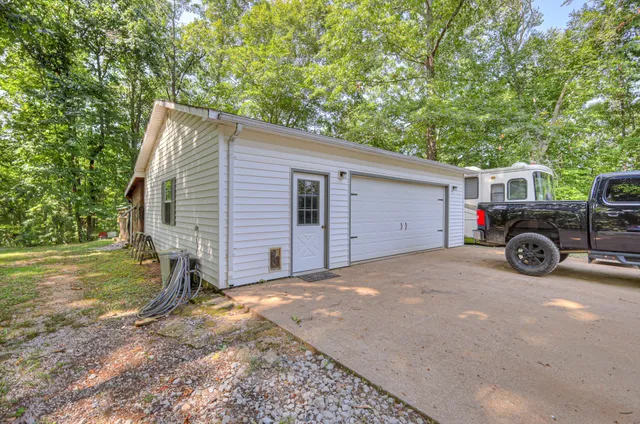 a backyard of a house with table and chairs
