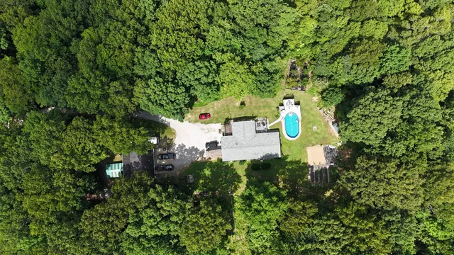 an aerial view of houses covered in trees