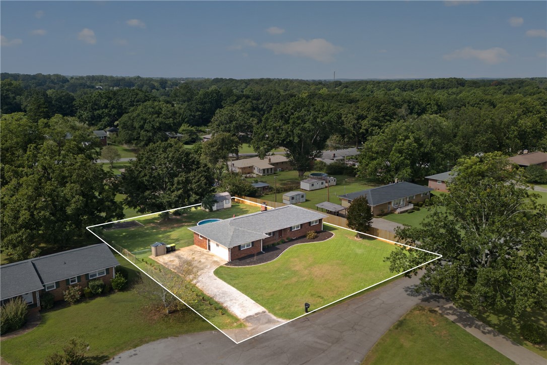118 Bryson Road Anderson, SC 29625 - Photo 30 of 36 An elevated perspective shows a sprawling brick ranch home situated on a manicured grassy lot.