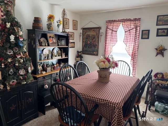 39 Courtney Lane Killingly, CT 06241 - Photo 8 of 10 a view of a dining room and livingroom with furniture wooden floor and a chandelier