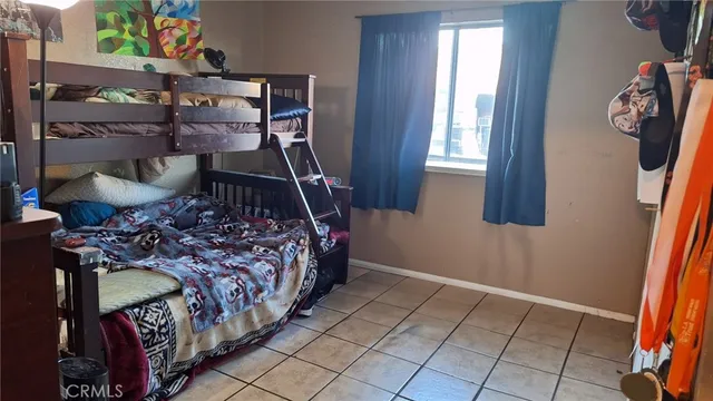 a bed sitting in a bedroom next to a window
