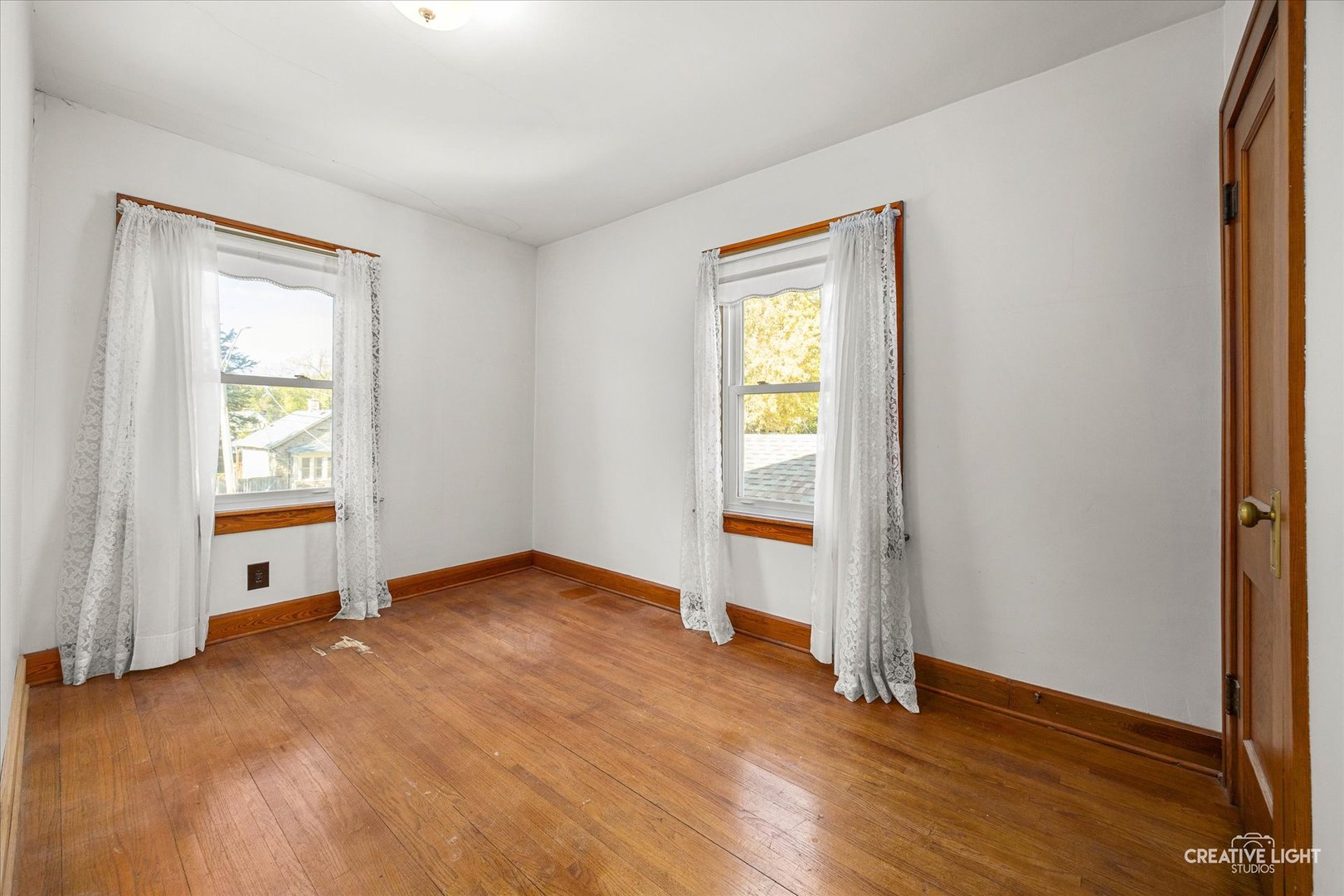 363 Orchard Street Elgin, IL 60123 - Photo 14 of 27 an empty room with wooden floor and a window