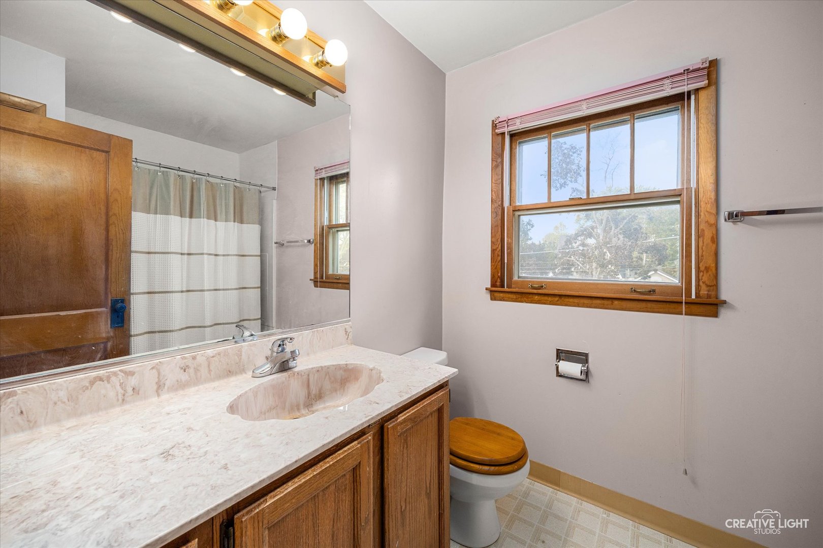 363 Orchard Street Elgin, IL 60123 - Photo 15 of 27 a bathroom with a granite countertop sink a toilet and mirror